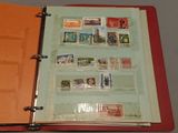 a red binder with stamps on it on a table