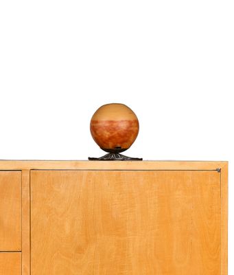 an apple sitting on top of a wooden cabinet