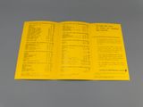 a close up of a yellow pamphlet on a gray surface