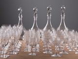 a lot of wine glasses and a decanter on a table