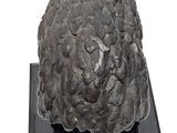 a black sculpture of a head on a black stand
