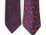 two ties with red and blue designs on them on a white surface