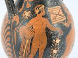 a black and orange vase with a painting on it