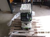 a picture of a green and white vacuum on a pallet