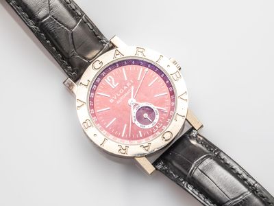 a watch that is sitting on a white surface