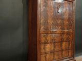 an old wooden cabinet with a drawer on top of it in a room