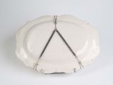 a white plate with a triangle on it on a white table
