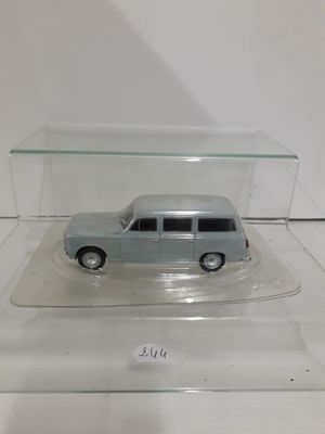 a small toy car in a glass case on a table