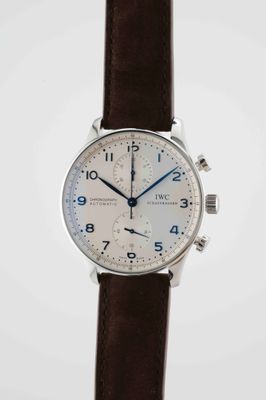 a close up of a wrist watch with a brown leather strap