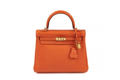 a small orange leather handbag on a white background