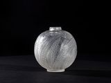 a glass vase sitting on a table with a black background