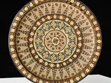 an image of a decorative plate sitting on top of a white table