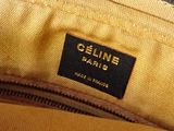 the inside of a yellow purse with a black label on it