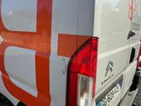 an orange and white van parked in a parking lot