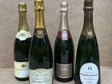 quatre bouteilles de champagne sont alignées sur une table