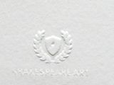 white paper with a crest and laurels on it