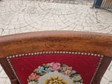 a red chair with a floral design on the back of it