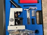 a blue case with a microscope and other items in it