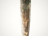 a close up of a knife on a white surface with a gray background