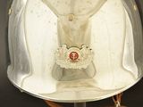 a silver helmet with a red emblem on it