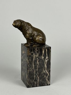 bronze sculpture of a bear on a marble block
