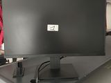 a computer monitor sitting on top of a desk