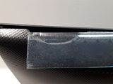 the back of a laptop computer sitting on top of a white table