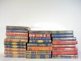 many books stacked on top of each other on a table