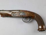 an old gun that is on display on a table