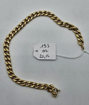 a gold chain bracelet with a price tag on it