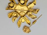 a gold brooch that has been placed on a table