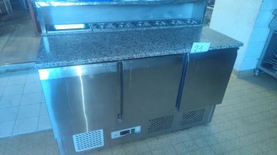 a stainless steel counter top with a microwave on it