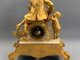 an image of a gold clock with a man and a child on it