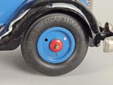 a close up of a toy car on a white surface