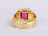 an image of a gold ring with a pink stone in the center