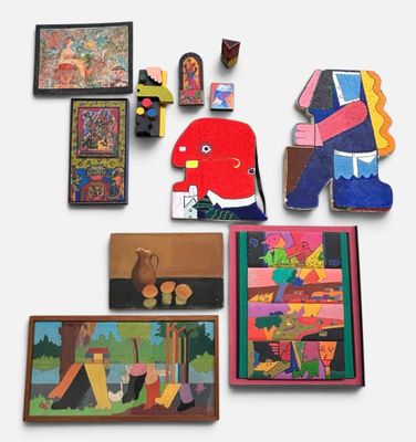 many pieces of art on display on the wall