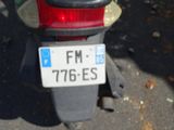 a motorcycle with a license plate on it parked on the street
