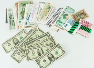 a pile of money sitting on top of a white table