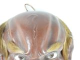 a brown mask with yellow hair on a white background
