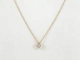 a gold necklace with a single diamond on a gold chain