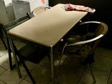 a table and chairs in a kitchen with a microwave