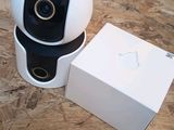 a small camera sitting next to a box on a table