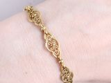 an image of a woman ' s arm with a gold bracelet on it