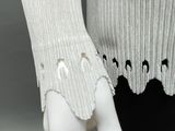 a mannequin hand holding a pair of gloves