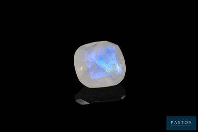 a white oplite stone on a black surface