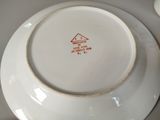 a white plate with a red and black design on it