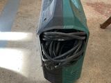 a green and black machine sitting on the floor