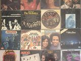 many records are stacked on top of each other on a table