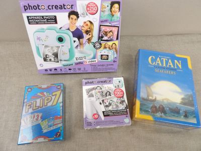 three children ' s books and a camera are on a couch