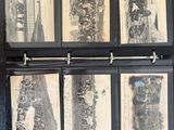 five old black and white photos on a black binder